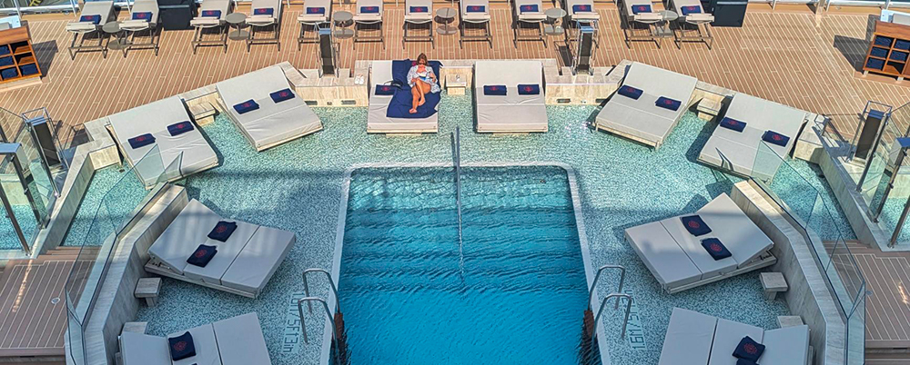 Person lounging in pool aboard the EXPLORA I