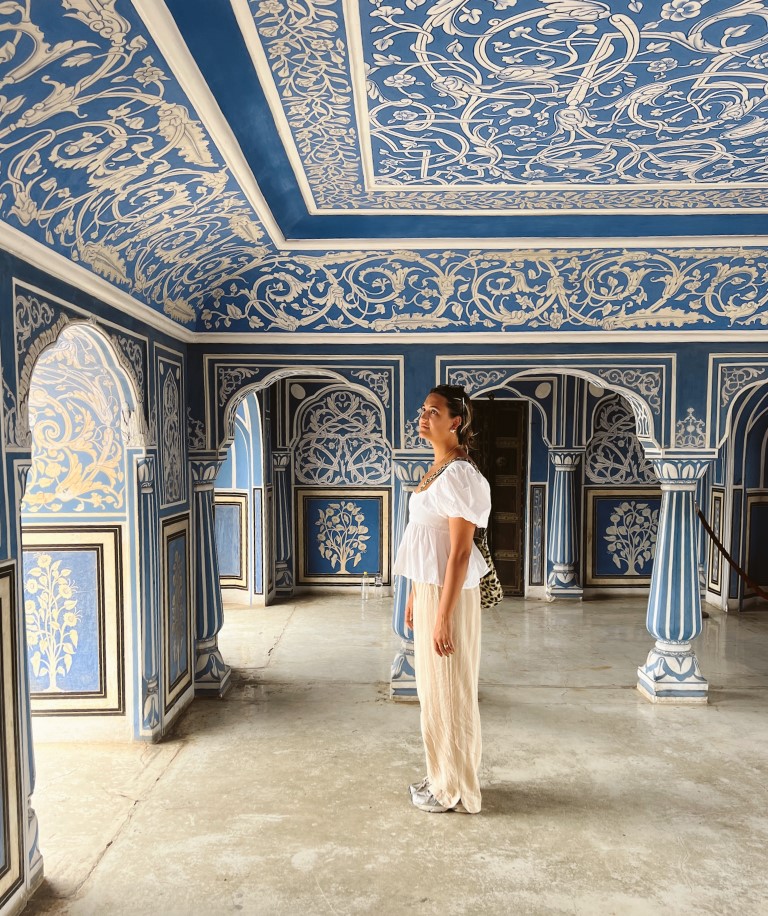 Lili Lebaron standing in the middle of the blue room city palace in Jaipur