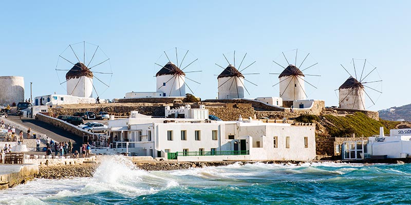 A row of windmills over the hillside and sea