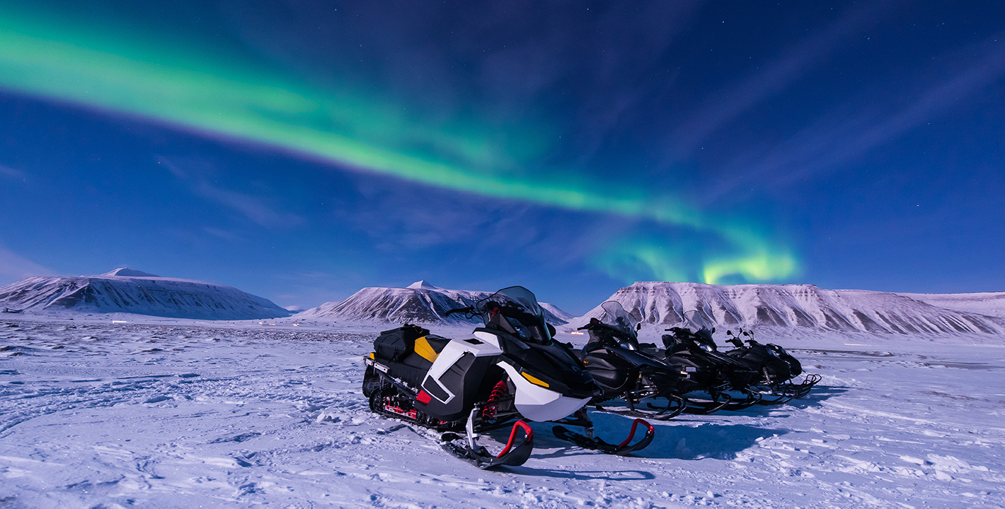 Snowmobiling under the Aurora Borealis