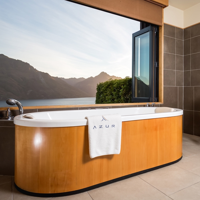 Bath overlooking lake at Azur Lodge