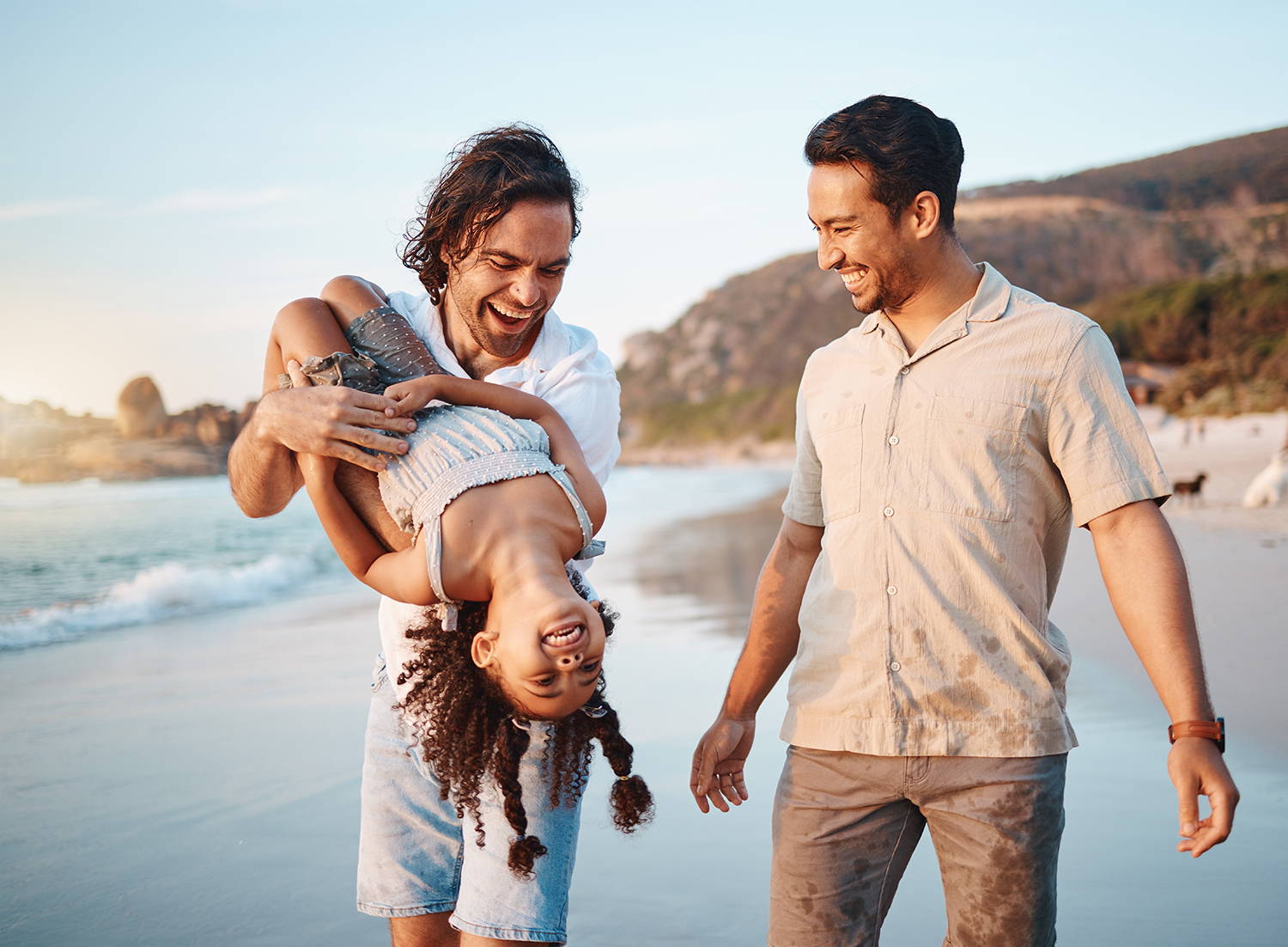 Family and child playing on the beach