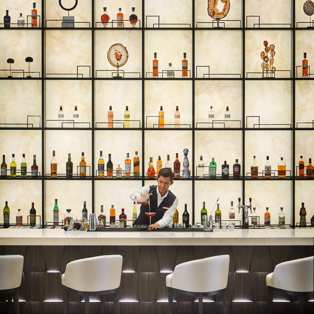 Bartender behind bar on an Explora Journey cruise
